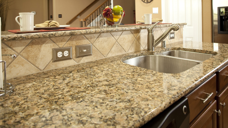 a brown granite kitchen counter with a sink