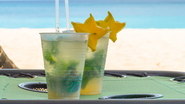 Two cocktails with starfruit on beach in Grenada