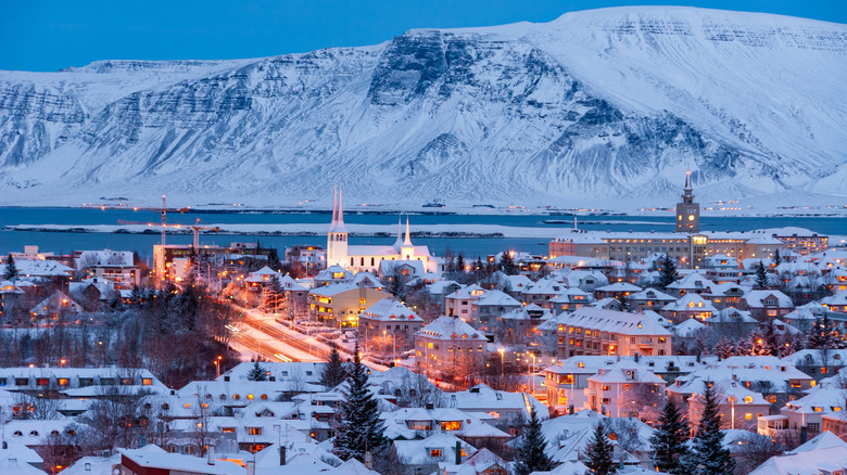 Reykjavik buildings covered in snow, a large mountain rising in the back