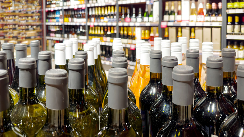 Wine bottles neatly arranged on shelves in a store