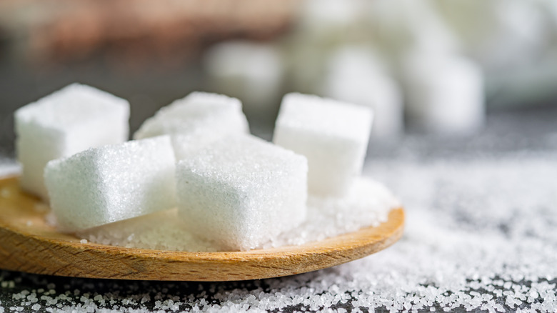 Sugar cubes on a wooden spoon