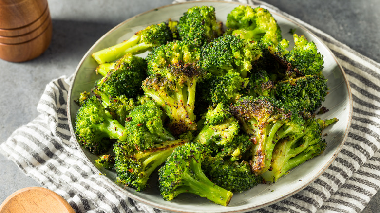 plate of roasted broccoli with salt