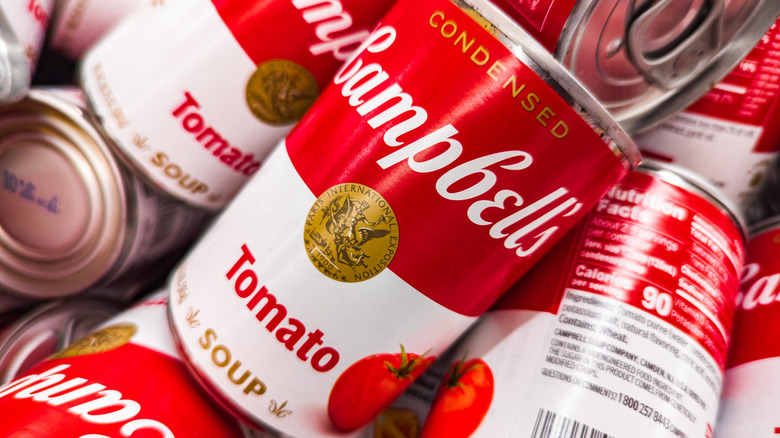 Cans of Campbell's tomato soup in a pile