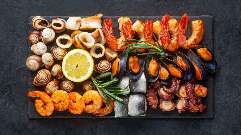 assortment of seafood arranged on cutting board