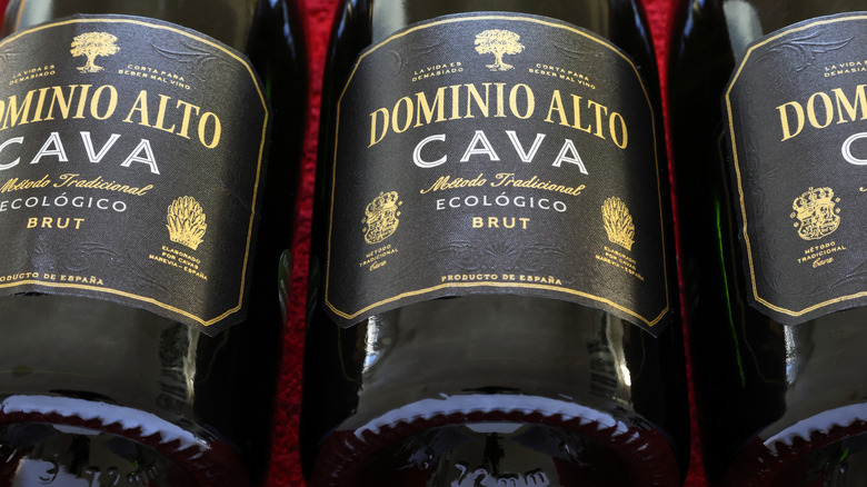 Several stacked bottles of cava