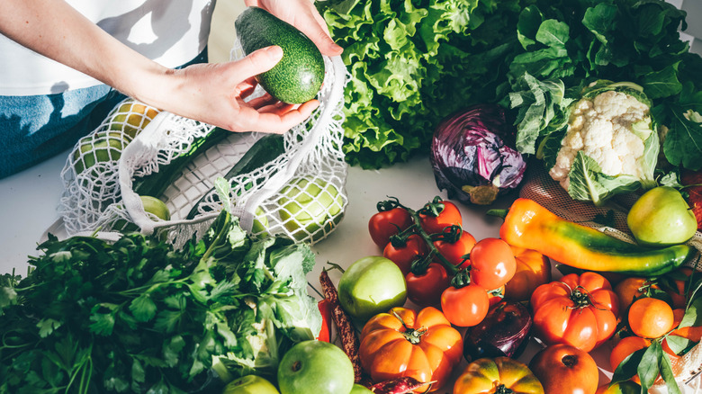 Person unloading bag of fruits and vegetables