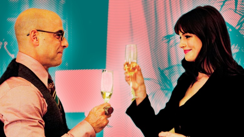 Anne Hathaway as Andy Sachs toasts Stanley Tucci and Nigel