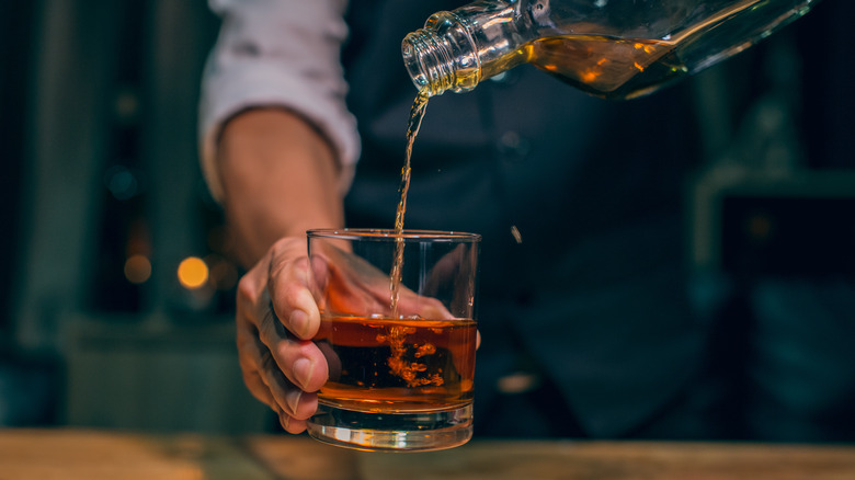 Bartender pouring bourbon