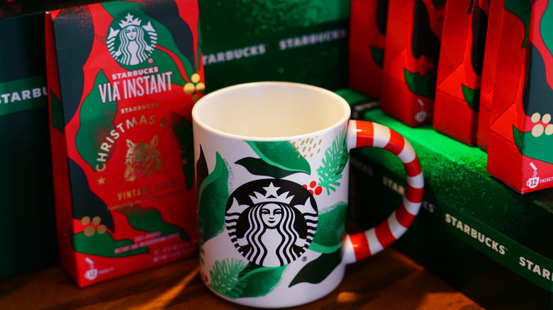 a christmas starbucks cup next to a starbucks  christmas blend