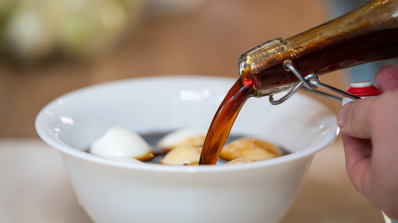 A shoyu-mirin marinade is poured over hard boiled eggs