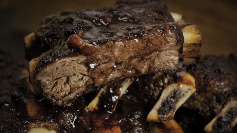 Cooked beef ribs covered with barbecue sauce
