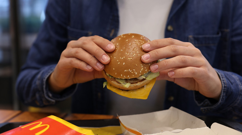 Woman holding McDonald's burger