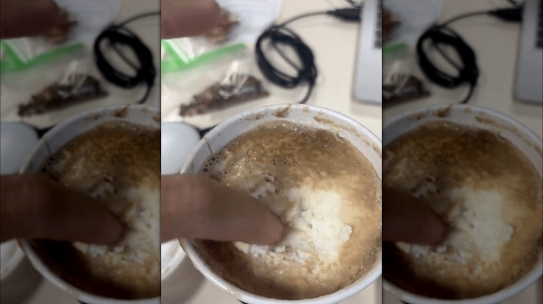 Person touching Starbucks protein latte.