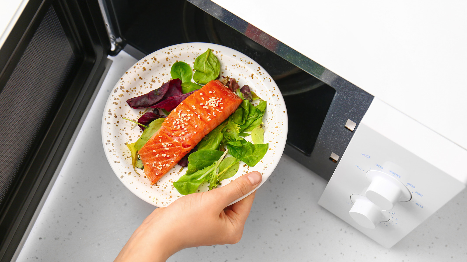 The Dish Towel Hack That Eliminates Fishy Odors From Your Microwave