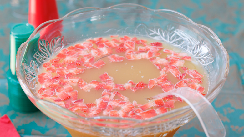 Plastic punch bowl with ladle filled with strawberry punch