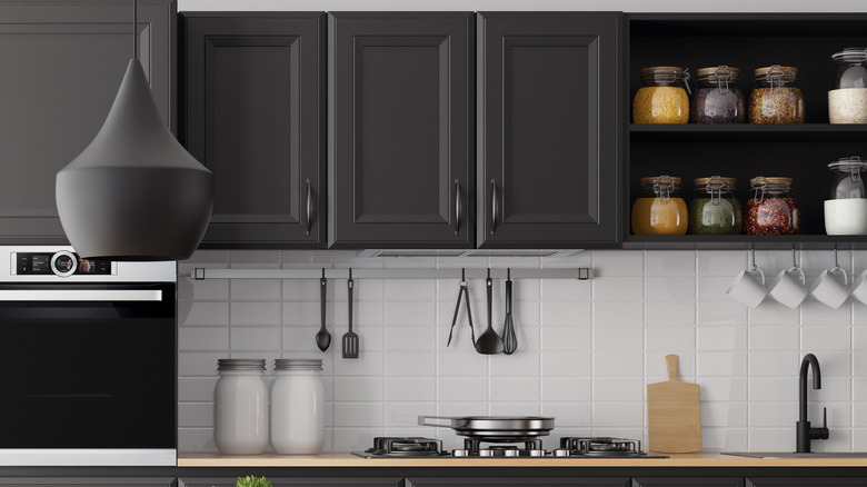 Modern kitchen with dark gray cabinets and white tile backsplash