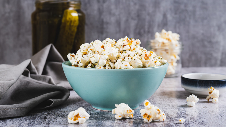 Two people sharing popcorn in a bowl