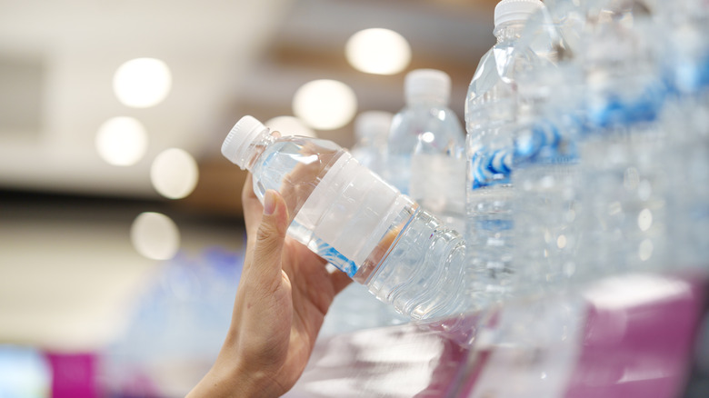 hand reaching for bottled water