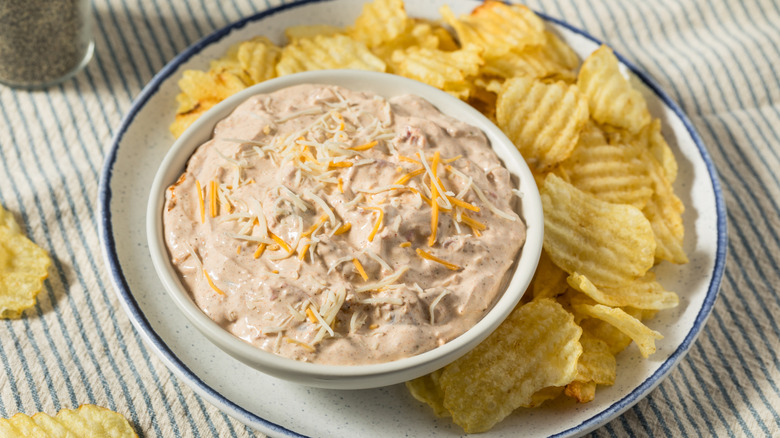 A taco dip with potato chips