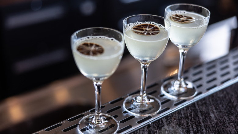Overhead view of citrus cocktails in glasses on a bar
