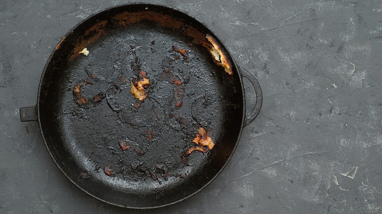 Top-down view of a dirty cast iron pan