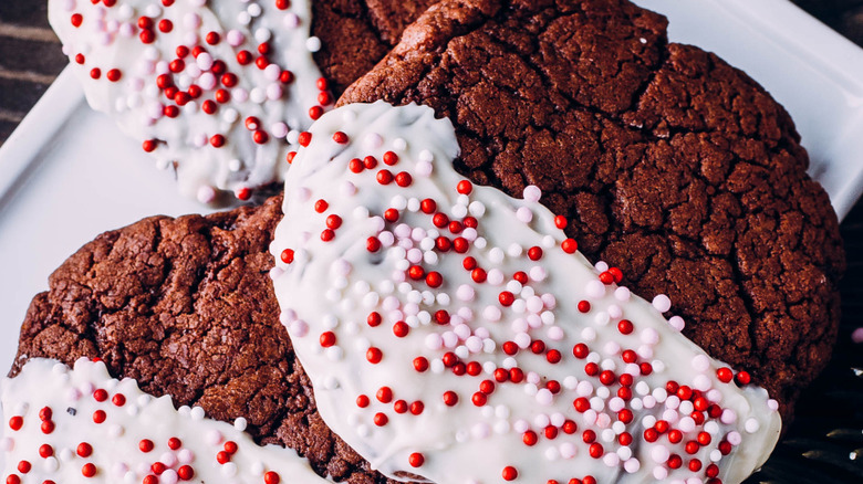 Chocolate cookies dipped in white chocolate and topped with dot sprinkles