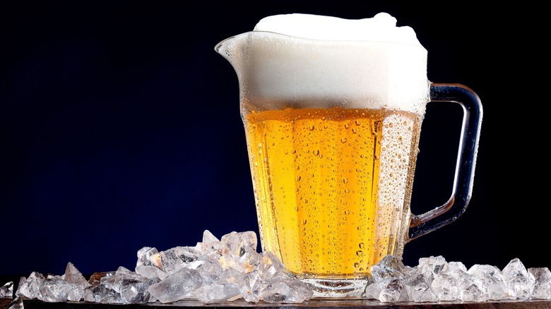 A pitcher of beer surrounded by ice