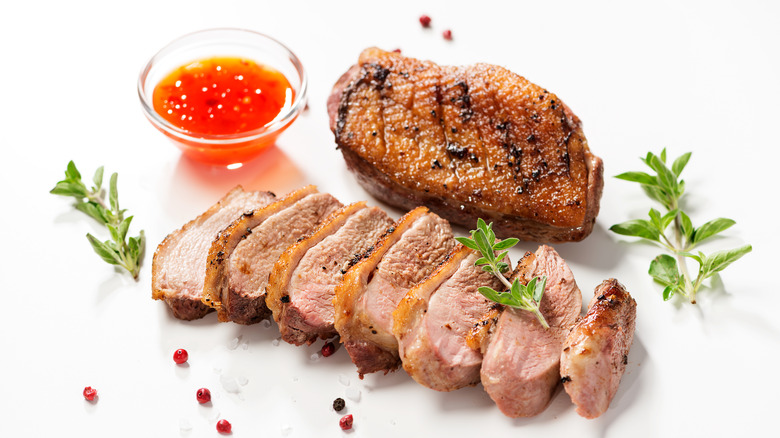 Sliced duck breast with herbs