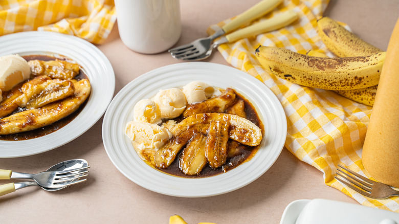 two plates of ice cream and bananas Foster