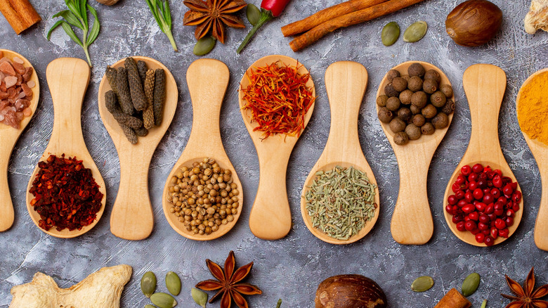 Wooden spoons holding various herbs and spices