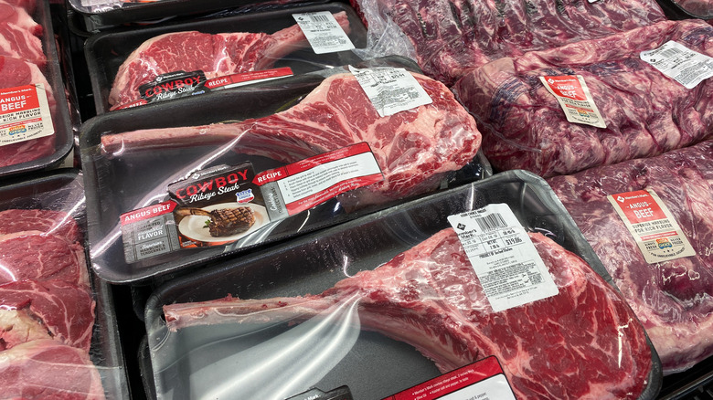 Large cuts of steak in their packaging in the meat cooler at Sam's Club