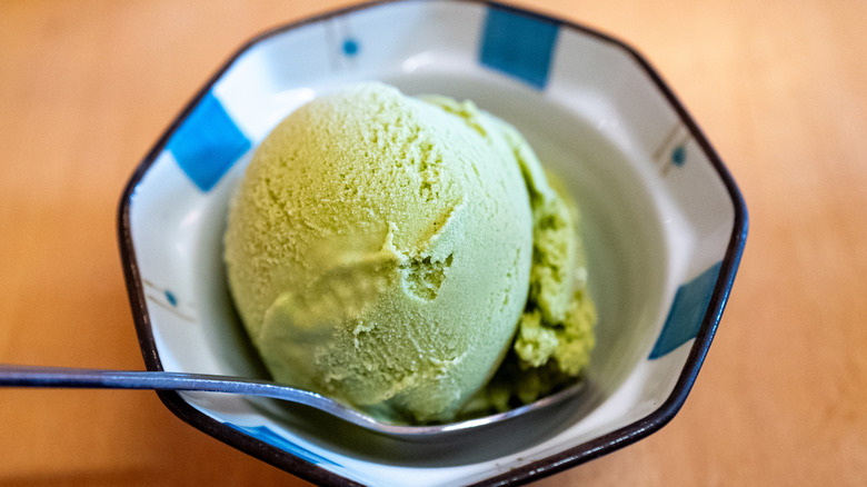 Overhead view of scoop of matcha ice cream in a bowl