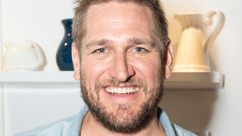 Curtis Stone smiles in blue shirt