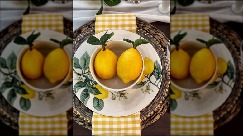 Place setting with a lemon plate and a bowl of lemons.