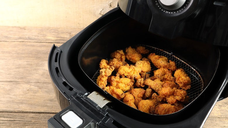 A close up shot of breaded crispy chicken shown cooked in an air fryer