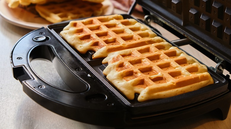 Waffles being made in a waffle iron