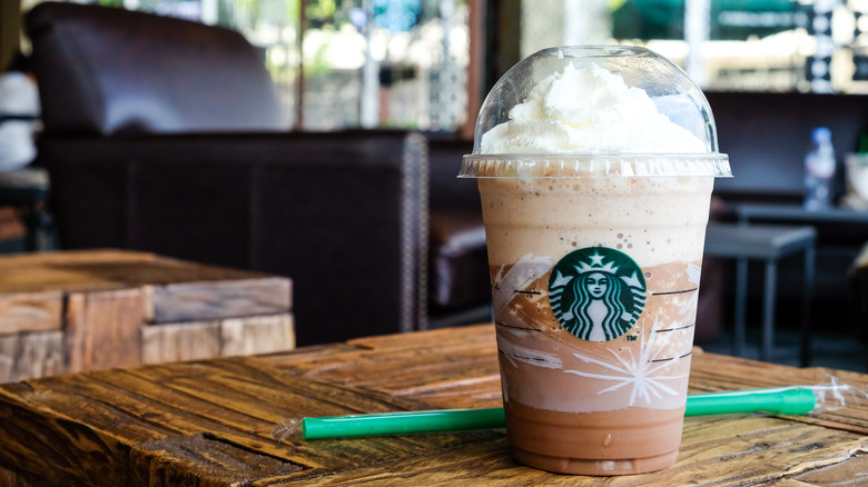 Starbucks Frappuccino sits on table with straw 