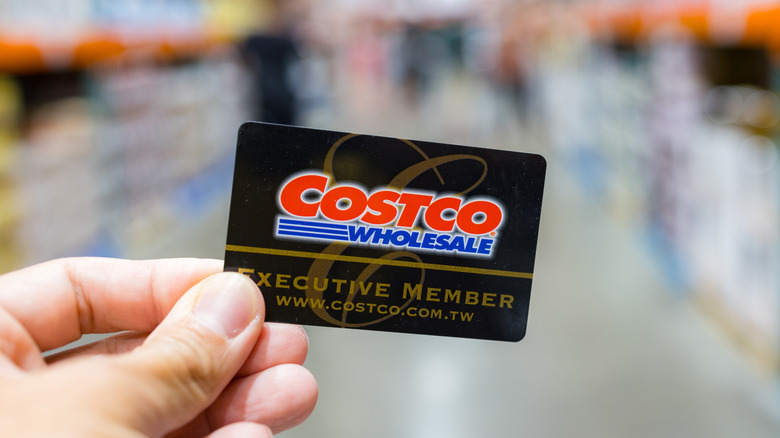 A person holds an executive member Costco card