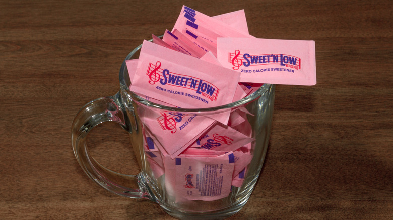 Foodie holding a packet of Sweet'N Low