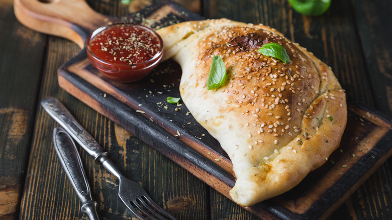 full calzone on a wooden tray