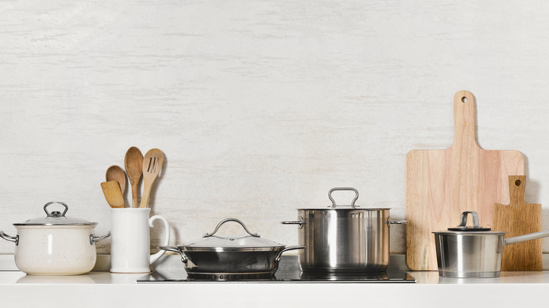 Pots, pans, and cutting boards on kitchen counter