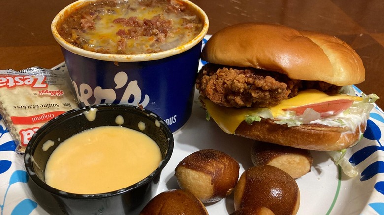 A Culver's chicken sandwich with a side of chili, pretzel balls, and cheese sauce