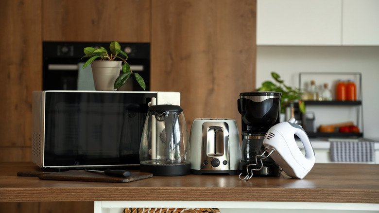 Microwave, toaster, coffee maker, and other kitchen appliances on counter