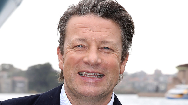 Jamie Oliver smiling, outdoors