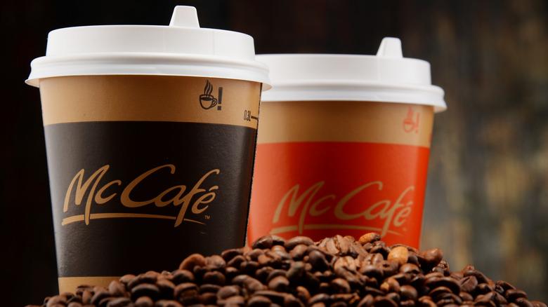Two McCafe cups in coffee beans 