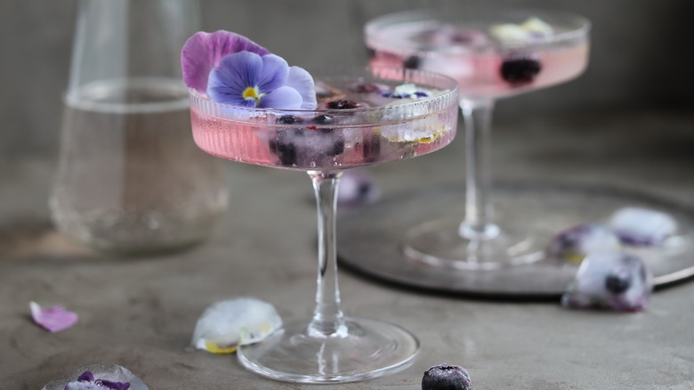 cocktail with edible flowers and blueberries