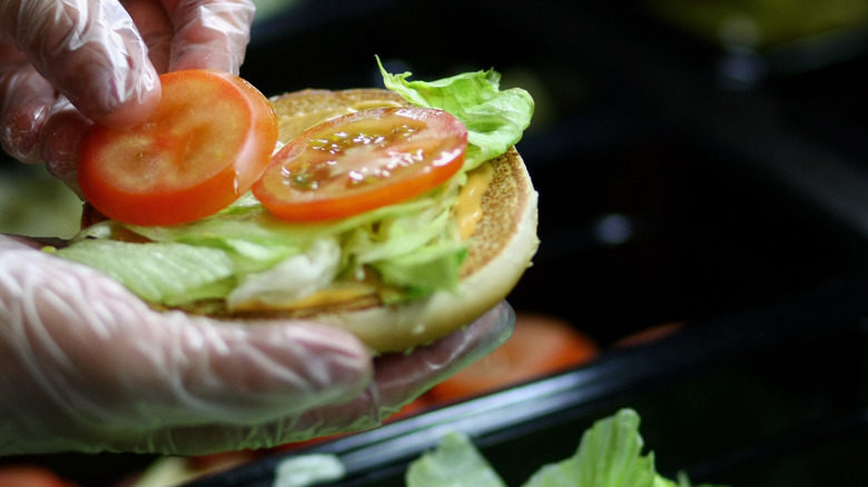 Burger King staff assembling a Whopper