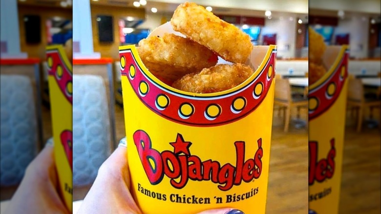 Hand holding Bojangles' hash browns