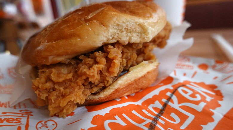 A chicken sandwich on Popeye's branded paper