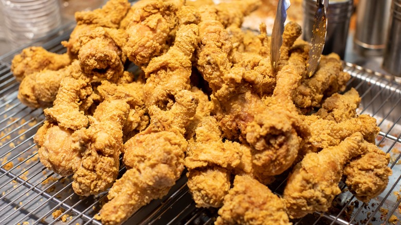 A pile of crispy fried chicken on a cooling rack